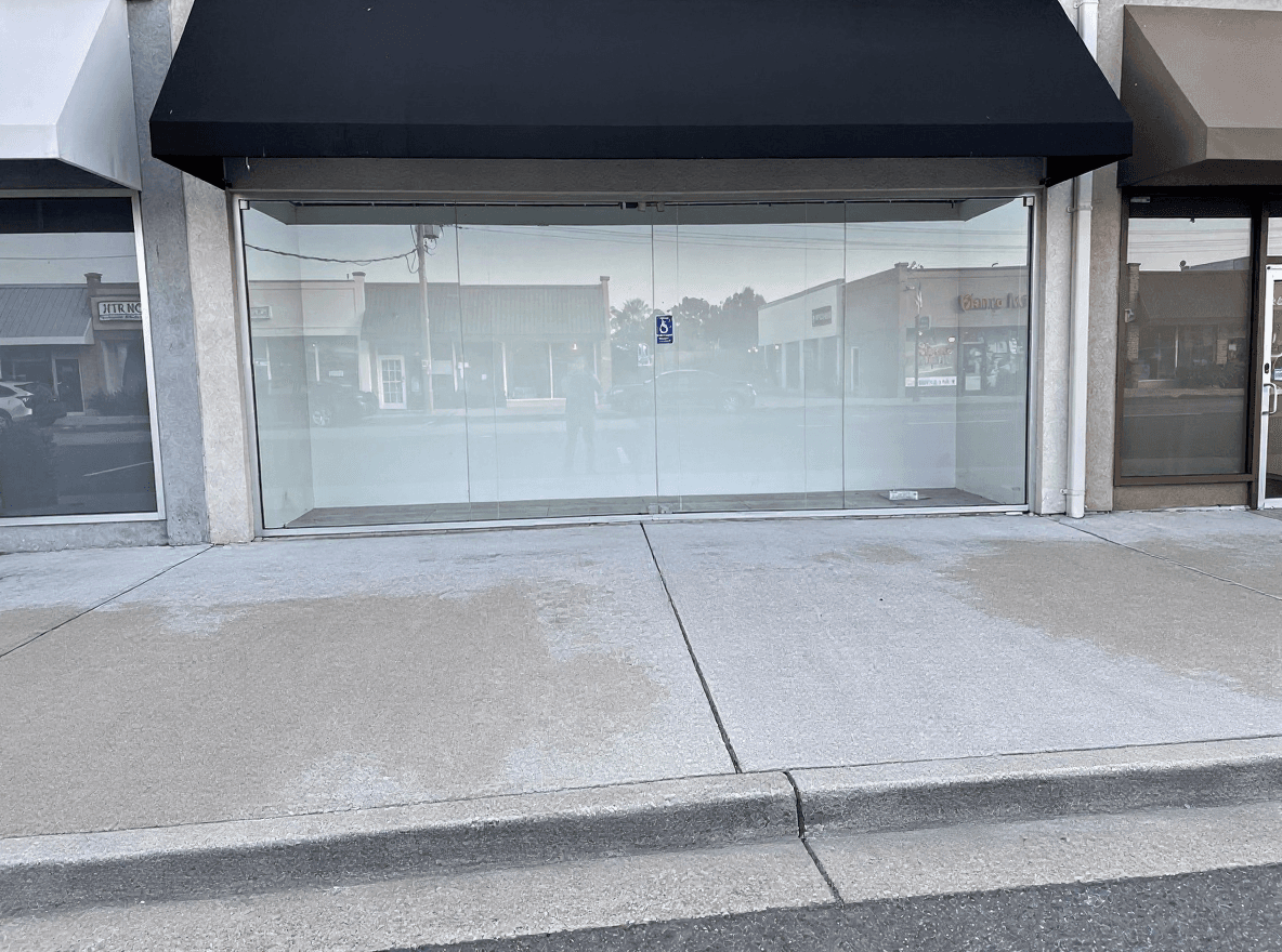 The same storefront entry with clean, even concrete after washing